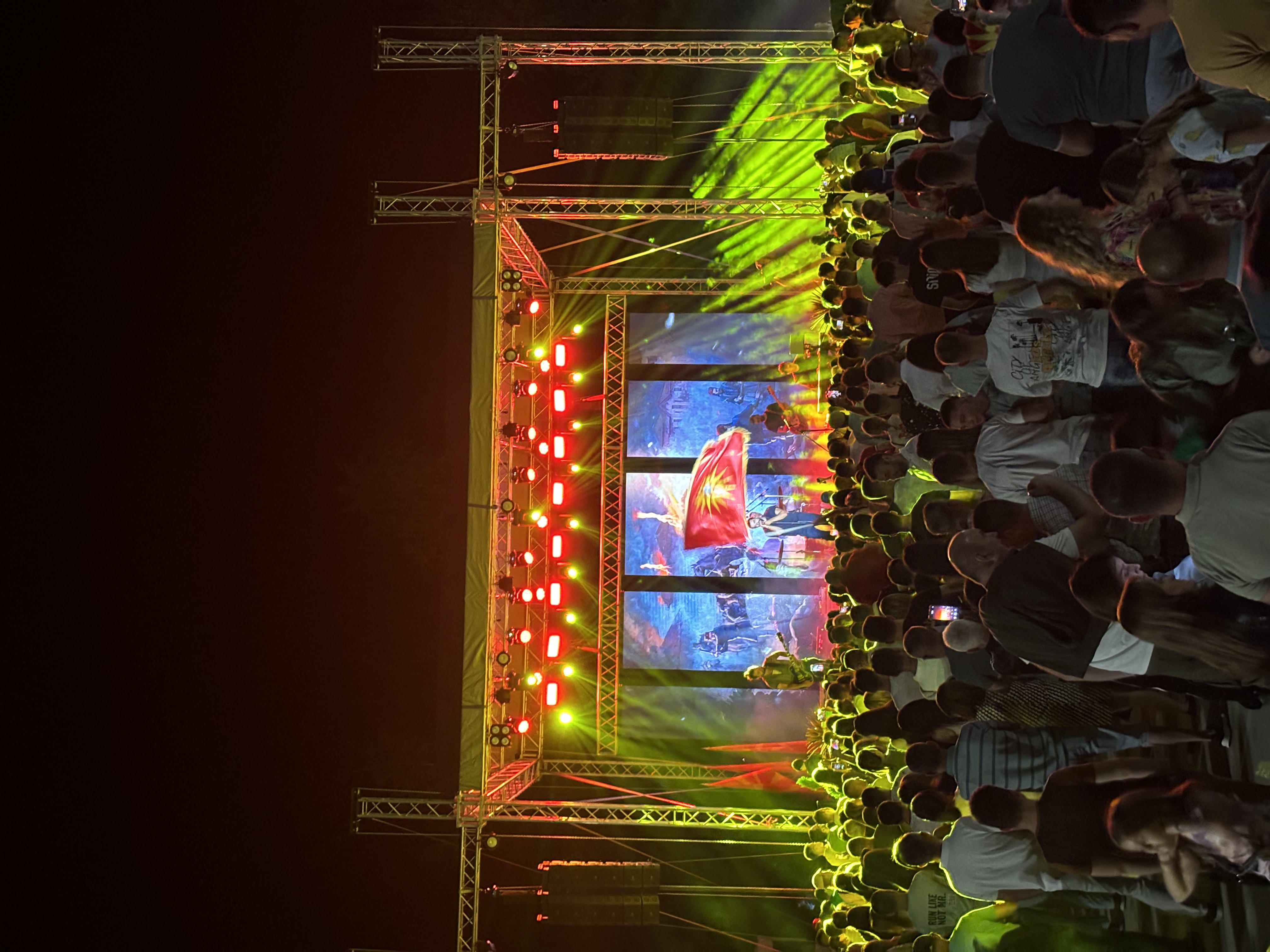Large outdoor concert with line arrays, LED towers, and stage production