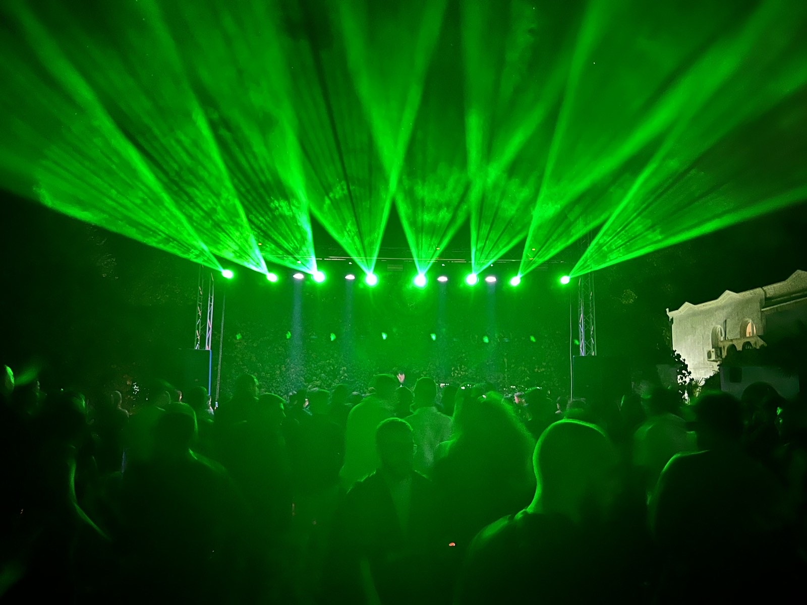 Outdoor concert with laser beams and moving-head fixtures